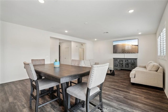 dining space with dark hardwood / wood-style floors