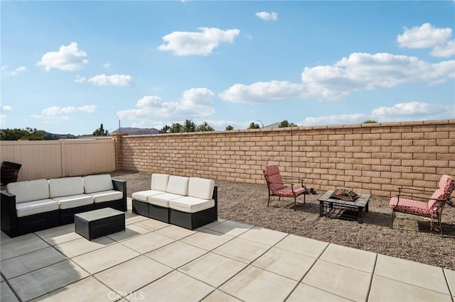 view of patio / terrace with an outdoor living space with a fire pit