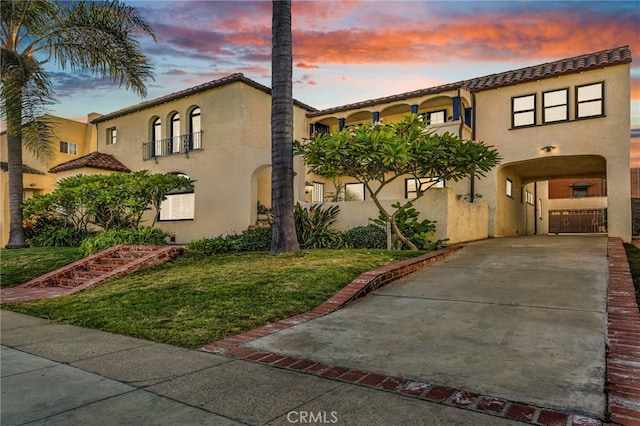 mediterranean / spanish home with a yard