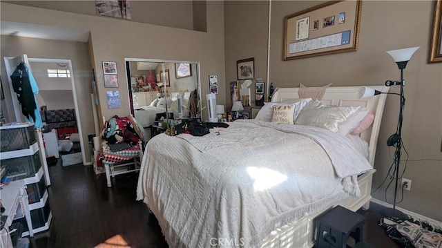 bedroom with a closet and dark hardwood / wood-style floors