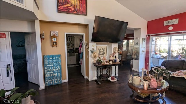 living room with dark wood-type flooring and vaulted ceiling