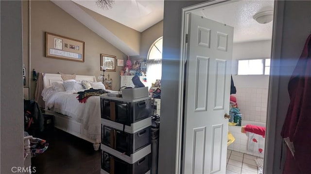 bedroom with light tile patterned floors and a textured ceiling