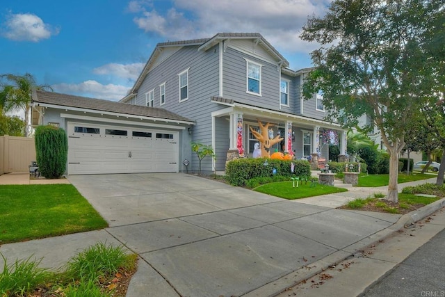 view of front of house featuring a porch, a garage, and a front lawn