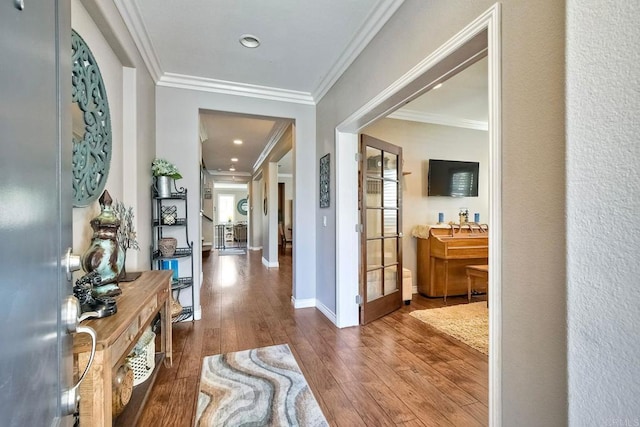 hall featuring hardwood / wood-style flooring and crown molding