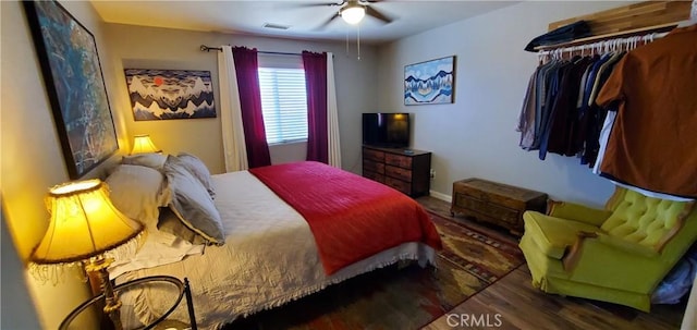 bedroom with ceiling fan and dark wood-type flooring