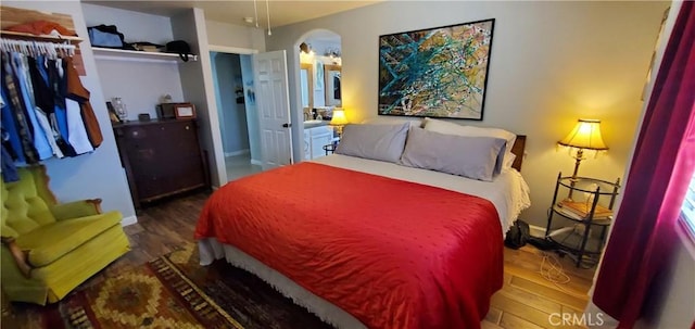 bedroom with dark wood-type flooring