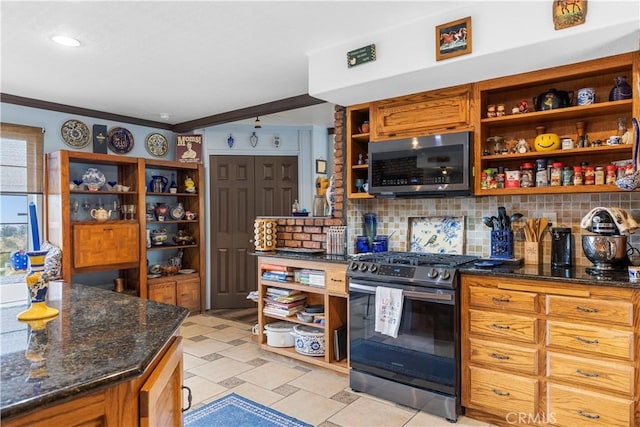 kitchen featuring backsplash, dark stone countertops, ornamental molding, light tile patterned floors, and stainless steel appliances