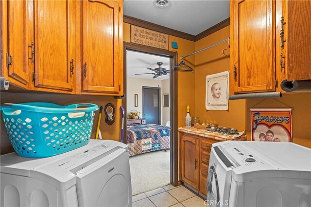 24601 Deertrail Dr, Tehachapi, CA 93561 - washroom with separate washer and dryer, cabinet space, crown molding, light tile patterned flooring, and a ceiling fan