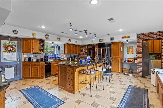 kitchen featuring decorative backsplash, brick wall, stainless steel fridge with ice dispenser, a kitchen island, and a breakfast bar area