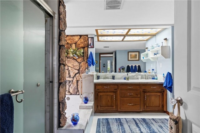 bathroom with tile patterned floors, vanity, and walk in shower