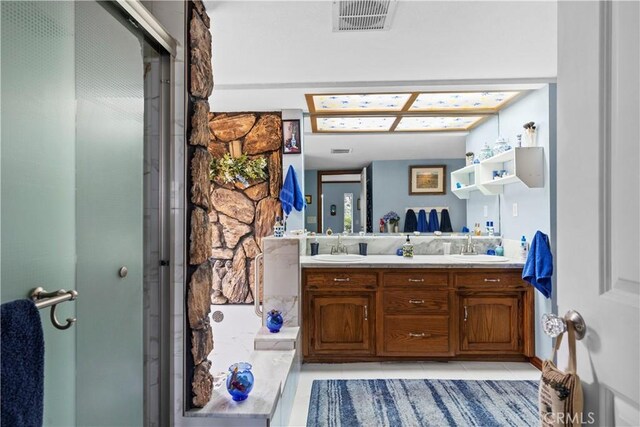 24601 Deertrail Dr, Tehachapi, CA 93561 - full bath with double vanity, a stall shower, and tile patterned floors