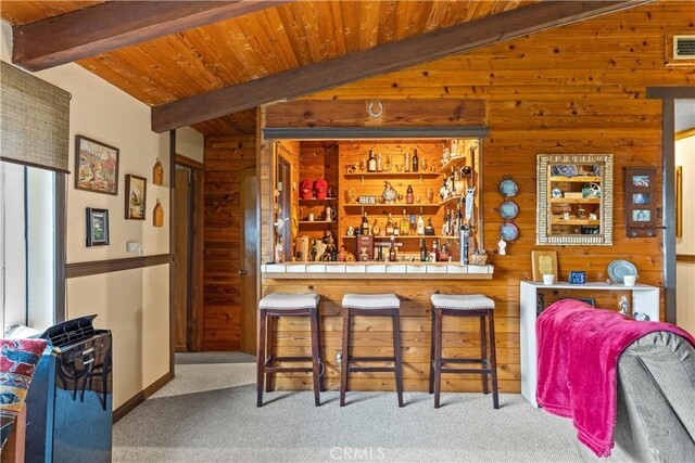 24601 Deertrail Dr, Tehachapi, CA 93561 - bar featuring wood walls, carpet floors, and wood ceiling with exposed beams