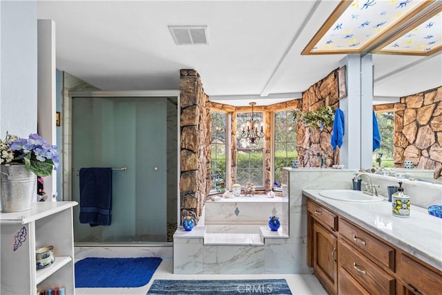 bathroom featuring a chandelier, shower with separate bathtub, vanity, and tile patterned floors