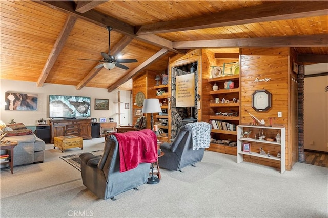 carpeted living room with wood walls, vaulted ceiling with beams, ceiling fan, and wooden ceiling