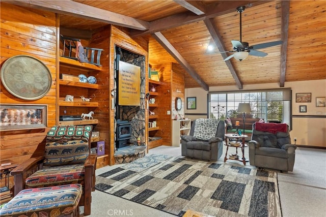 living room featuring vaulted ceiling with beams, a wood stove, ceiling fan, and wood ceiling