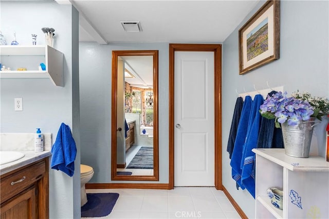 bathroom with tile patterned floors, vanity, and toilet