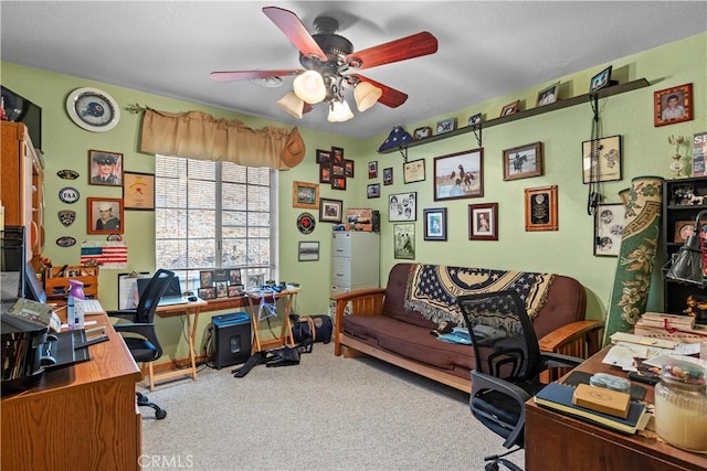 carpeted office featuring ceiling fan