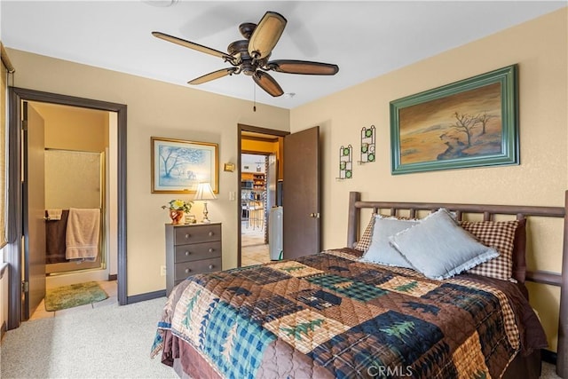 carpeted bedroom with ensuite bath and ceiling fan