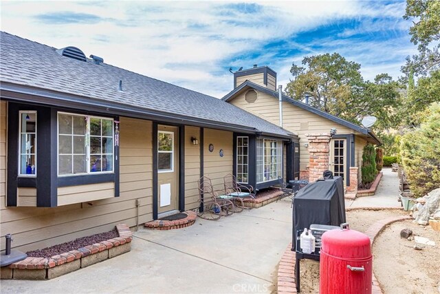 24601 Deertrail Dr, Tehachapi, CA 93561 - back of house with a patio, a shingled roof, and a chimney