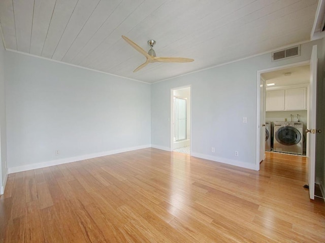 empty room featuring separate washer and dryer, ornamental molding, ceiling fan, light hardwood / wood-style floors, and wooden ceiling