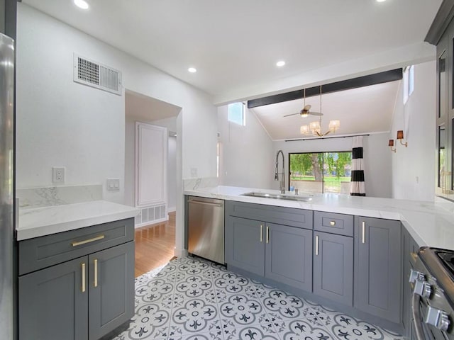 kitchen with stainless steel appliances, sink, hanging light fixtures, and gray cabinetry