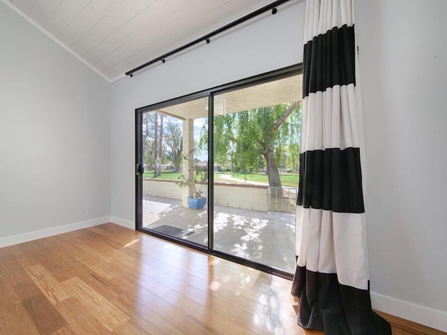 unfurnished room with lofted ceiling and light hardwood / wood-style floors