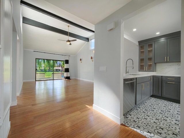 kitchen featuring sink, tasteful backsplash, lofted ceiling with beams, gray cabinets, and dishwasher