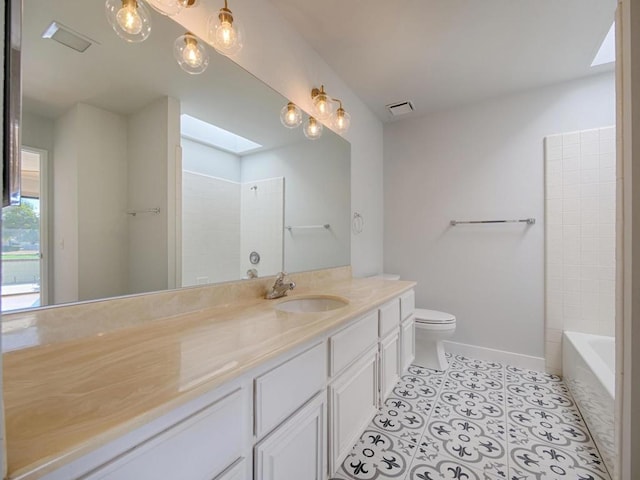 full bathroom with bathing tub / shower combination, a skylight, vanity, tile patterned floors, and toilet