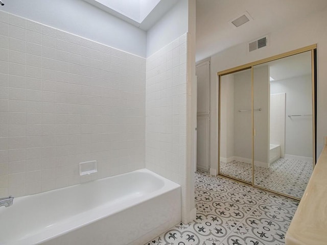 bathroom with plus walk in shower and a skylight