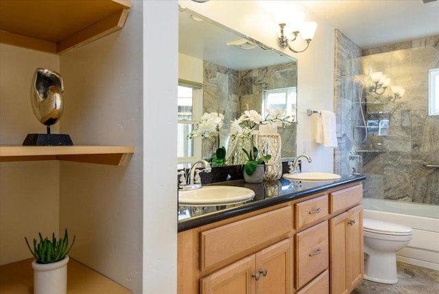 full bathroom with toilet, vanity, and tiled shower / bath combo