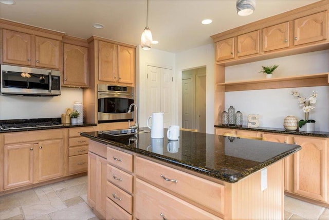 kitchen featuring pendant lighting, a center island, stainless steel appliances, light brown cabinetry, and dark stone counters