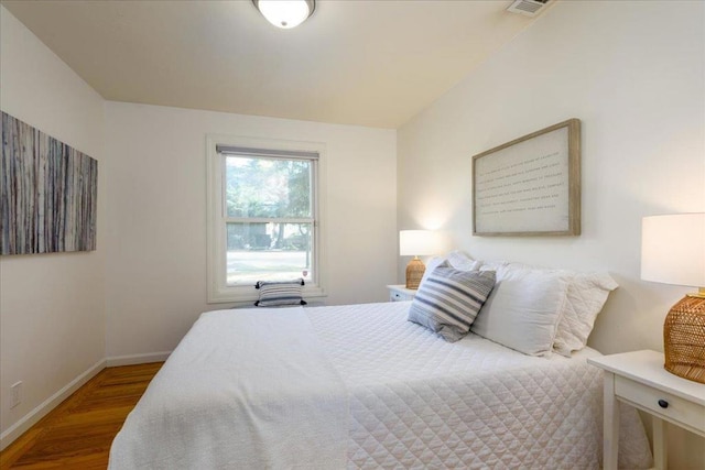 bedroom with hardwood / wood-style floors