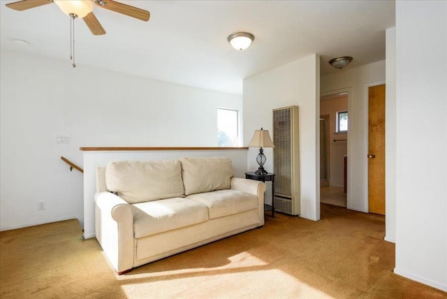 unfurnished living room featuring ceiling fan, a wealth of natural light, and carpet floors