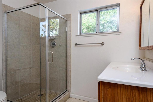 bathroom featuring an enclosed shower, vanity, and toilet