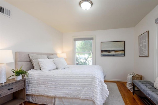 bedroom with dark hardwood / wood-style floors