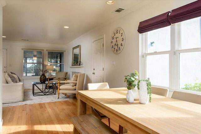 dining room featuring ornamental molding and light hardwood / wood-style floors