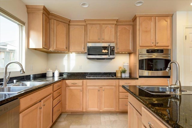 kitchen with sink, light brown cabinets, and stainless steel appliances