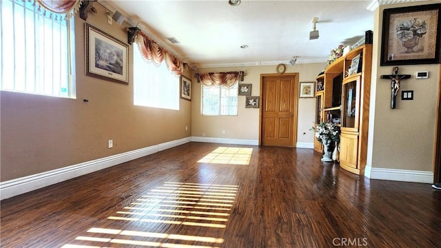 spare room with dark hardwood / wood-style floors and ornamental molding