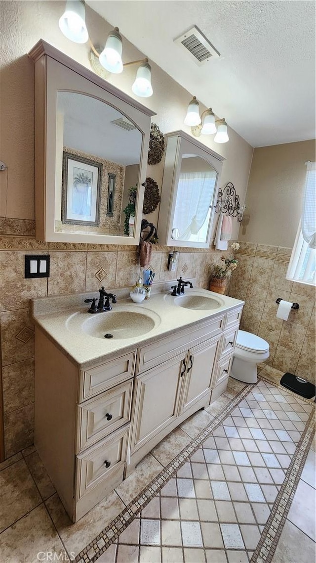 bathroom featuring tile walls, tile patterned floors, vanity, and toilet