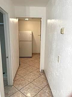 hallway featuring light tile patterned floors