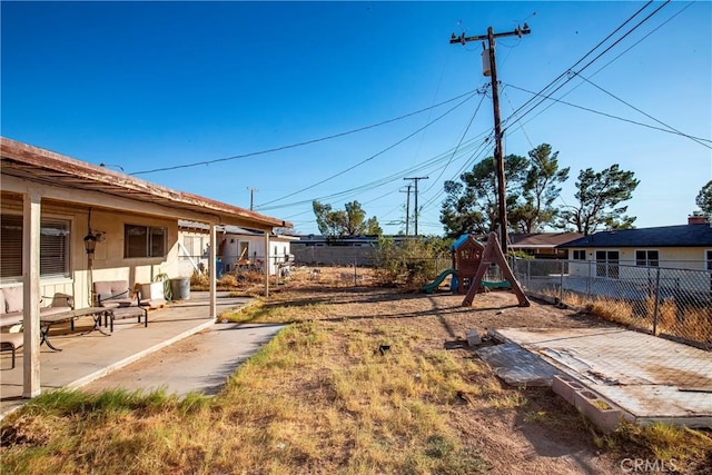 view of yard with a playground and a patio