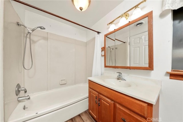 bathroom featuring hardwood / wood-style floors, shower / bath combination with curtain, and vanity