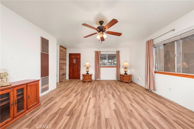 unfurnished living room featuring light wood-type flooring and ceiling fan