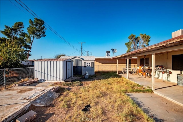 view of yard with a patio area and a storage shed