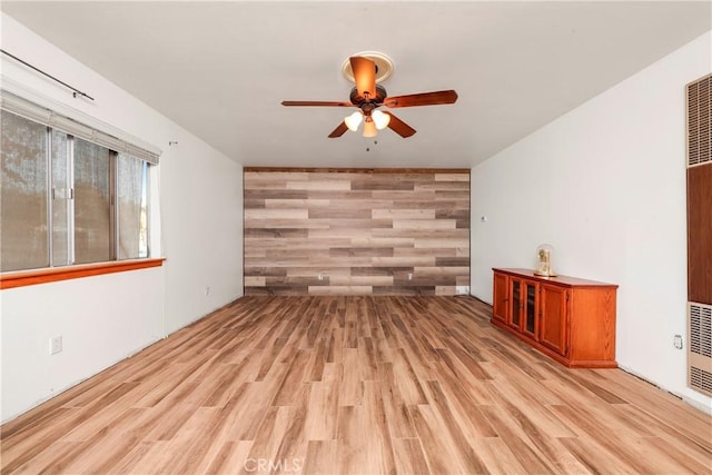 unfurnished living room with light hardwood / wood-style flooring and ceiling fan