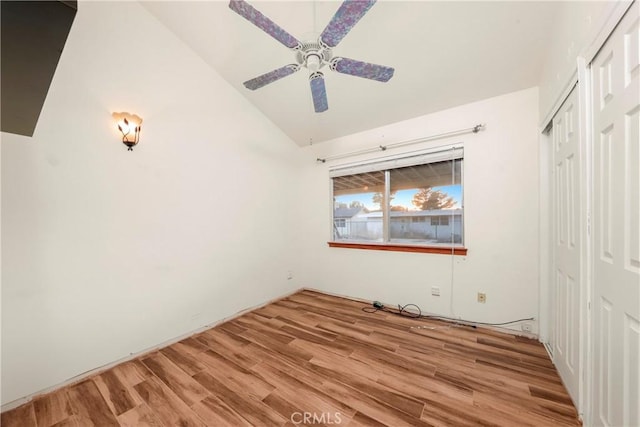 unfurnished bedroom featuring ceiling fan, light hardwood / wood-style flooring, and vaulted ceiling