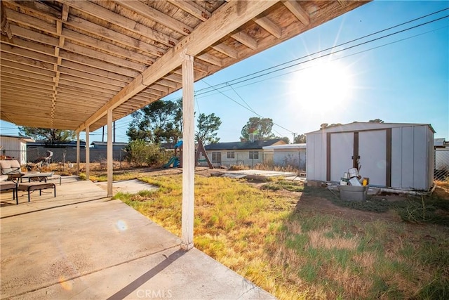 view of yard with a shed and a patio