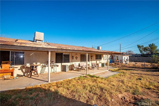 rear view of property featuring cooling unit and a patio area