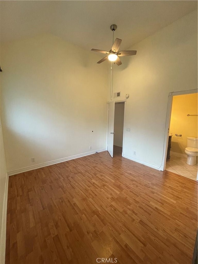 spare room with hardwood / wood-style floors, ceiling fan, and vaulted ceiling