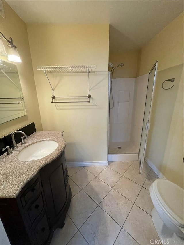 bathroom featuring tile patterned floors, a shower, vanity, and toilet